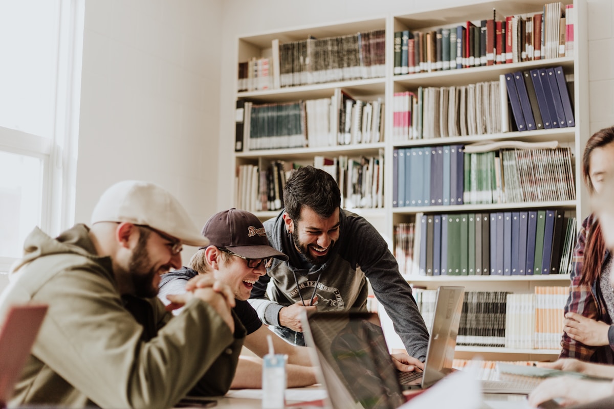 Earn cohort members practising AI tools on laptops during a Fraser Street session